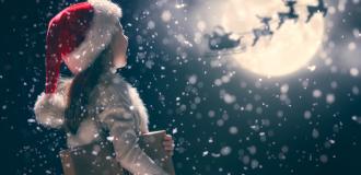 child at christmas looks at sleigh passing the moon 