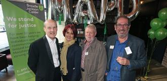 Chris, Esther, Andrew and Elkan pose in front of MAPD balloons