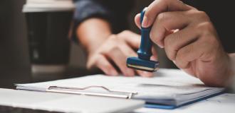 A person stamping a legal document