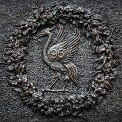 A brass plate showing the Liver bird surrounded by a wreath in commemoration of Hillsborough. 