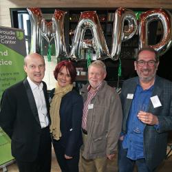 Chris, Esther, Andrew and Elkan pose in front of MAPD balloons