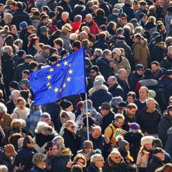 An EU flag flown in a group of people.