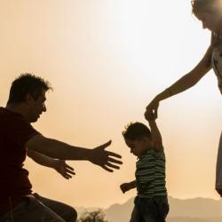 Mother and father holding childrens hand