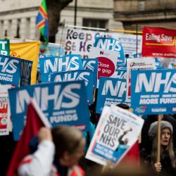 crowd of people protesting to save NHS