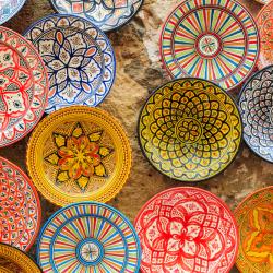 A photo of various colourful patterned dishes photographed from above. They have geometric patterns in different colours