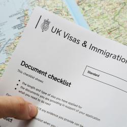 immigration application document over a world map